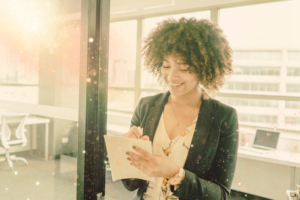 Woman smiling at work due to practicing positive work affirmations