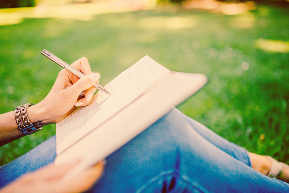 woman writing down affirmations